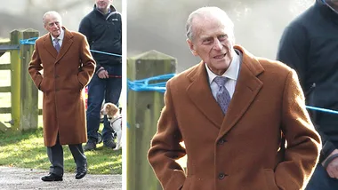 Man in a brown coat walking outdoors on a sunny day, accompanied by others and a dog nearby.