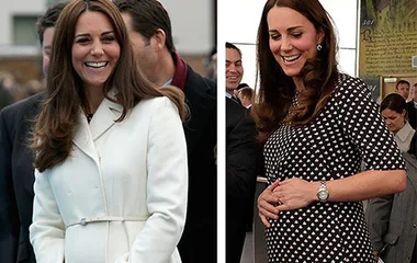 "Pregnant woman in white coat and patterned dress, smiling and holding baby bump, surrounded by people."