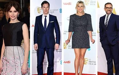 Four individuals in formal wear on a red carpet at an award event.