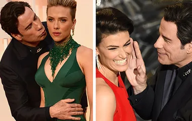 John Travolta awkwardly embraces two women on the Oscars red carpet, one in a green dress and another laughing in red.