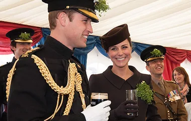 The Duke and Duchess of Cambridge celebrate St. Patrick's Day wearing military uniforms and sharing drinks.