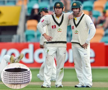 Two Australian cricketers on the field with a diamond band overlay.