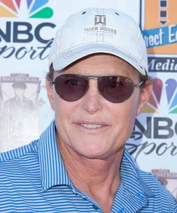 I'm unable to identify the person in the image, but it shows someone in sunglasses, a white cap, and a blue striped shirt.