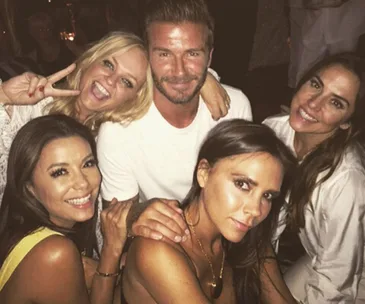 "Group of friends celebrating at a party, smiling and posing for a photo."