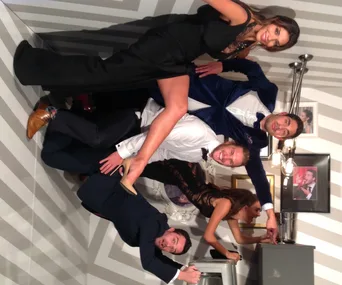 Group enjoying an anti-gravity room at the Logies, playfully posing and defying gravity on striped walls and ceiling.
