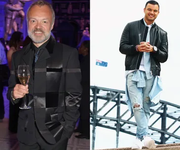 A man in a black suit holding a glass, and another in a casual outfit with a bridge in the background.