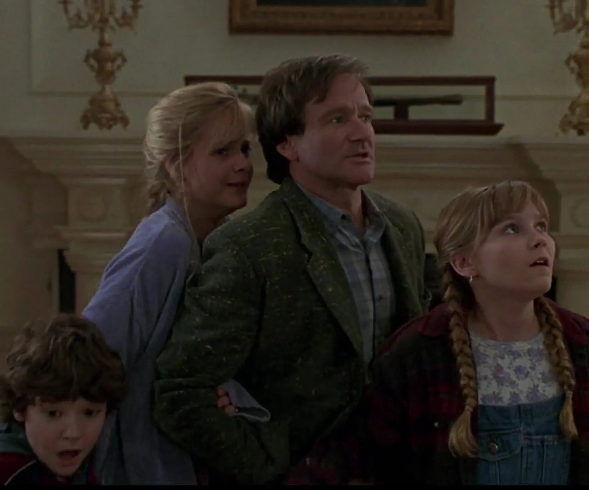 A group of four characters from the original "Jumanji" film look surprised and concerned, standing indoors.