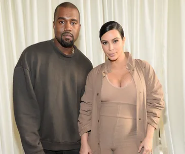 Two individuals posing in neutral-toned clothing at a fashion event in New York.