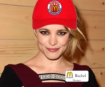 Person wearing a red McDonald's hat and a dark red outfit with a name tag that says "Rachel, Manager."