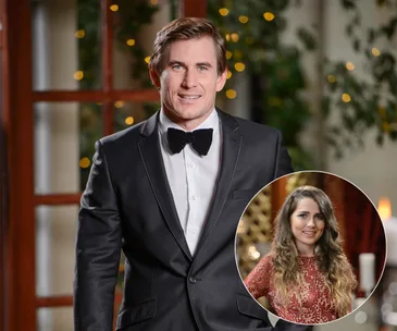 Man in a tuxedo with bow tie, inset of a smiling woman in a red dress, both in a warmly lit room.