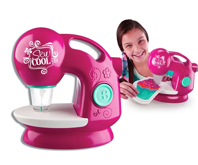 Young girl smiling while using a pink Sew Cool sewing machine to create a colorful fabric design.