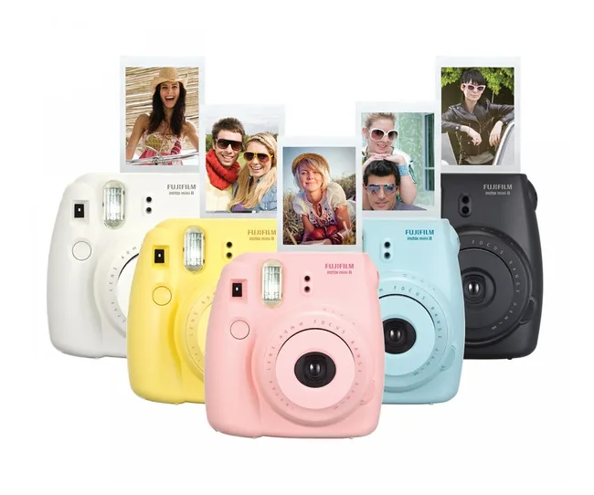 Five Fujifilm Instax Mini 8 cameras in different colors with instant photos emerging from each.