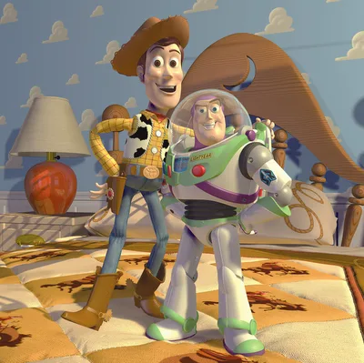 Buzz Lightyear and Woody stand on a colorful bed in a room with cloud wallpaper, from the movie Toy Story.