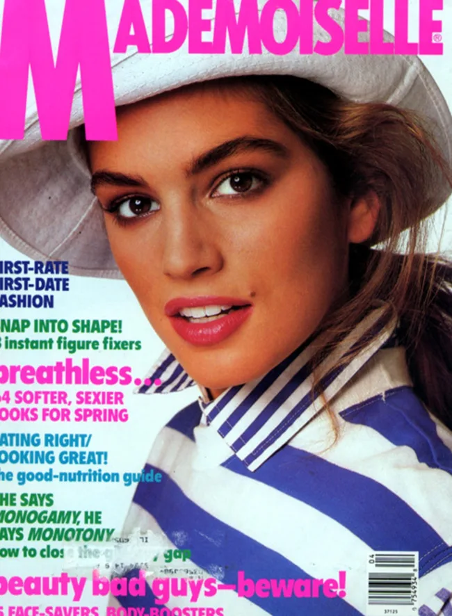 Cover of Mademoiselle magazine featuring a woman in a white hat and blue-striped shirt.