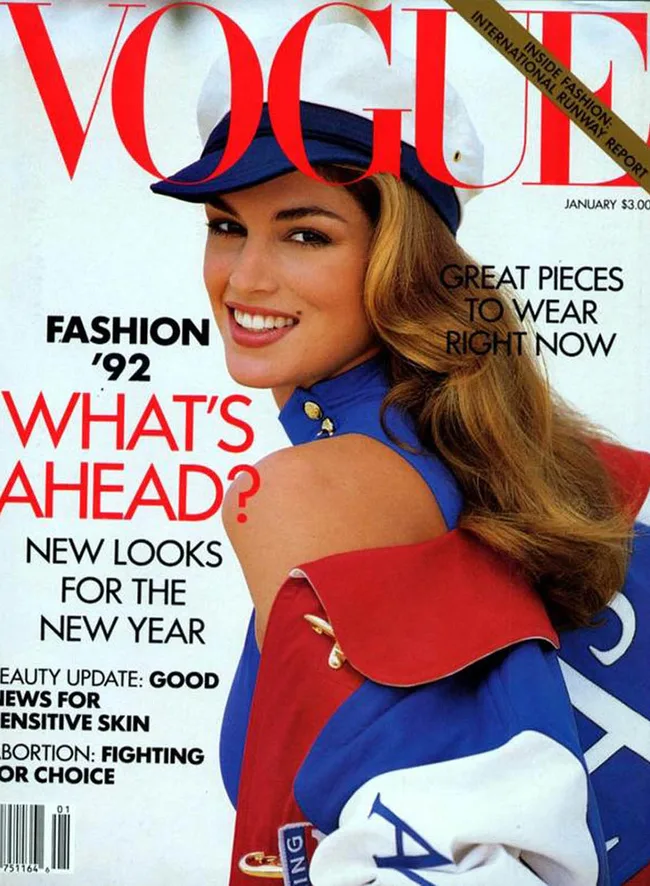 Cover of Vogue January 1992 with model in a blue and white hat and blue outfit, smiling. Text on fashion and style.