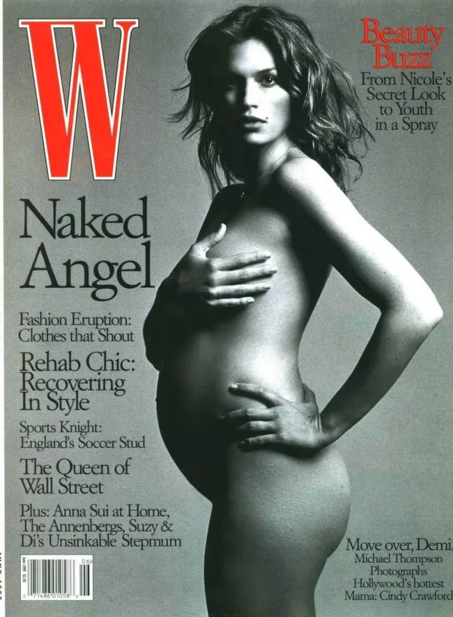 Black and white W magazine cover featuring a pregnant woman, hands covering her chest, titled "Naked Angel".