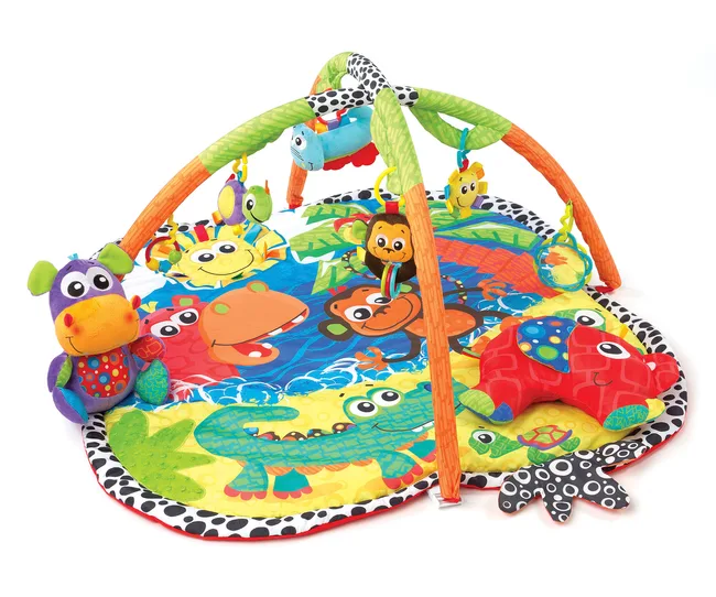 Colorful baby activity mat with animal designs and plush toys hanging from arches.