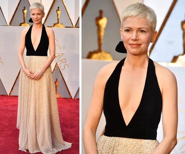 Woman in a black and beige gown on the Oscars red carpet.