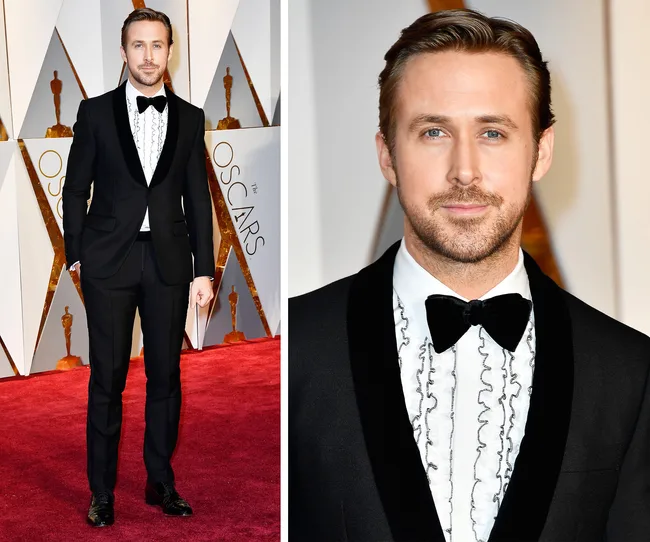 Actor in black tuxedo with ruffled shirt and bow tie on the Oscars red carpet.