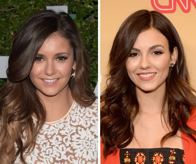 Two women with long brown hair smiling at the camera, side by side, wearing formal attire.
