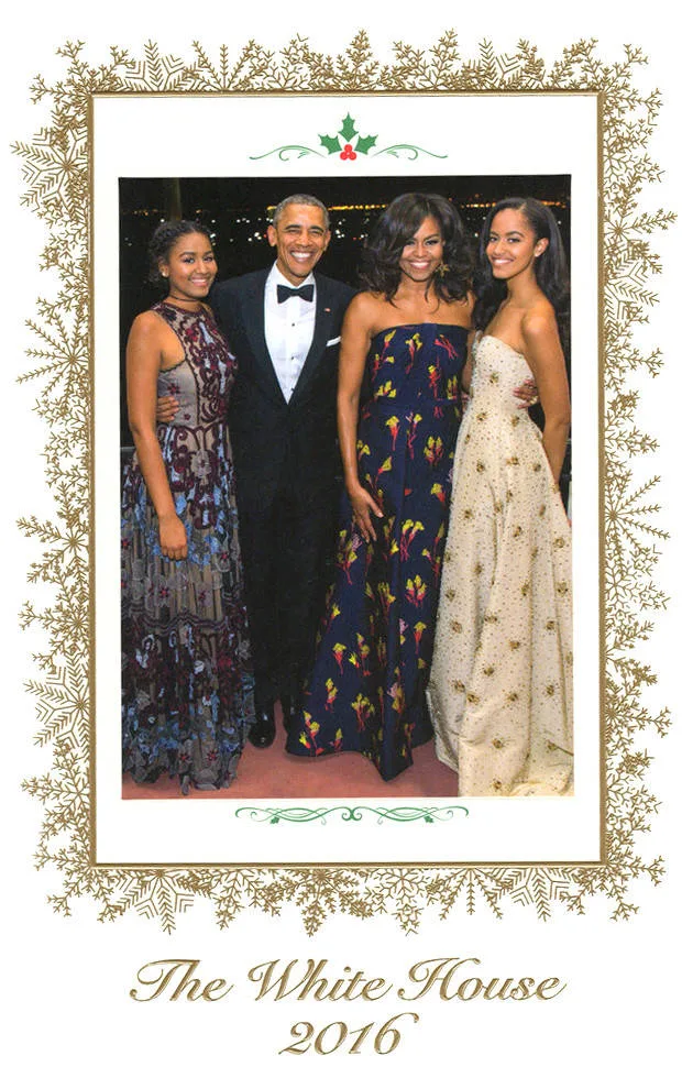 A family stands together in formal attire at the White House, 2016. They are framed by decorative gold and greenery.