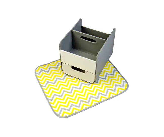 Nursery storage organizer with a yellow and gray chevron-patterned changing mat.