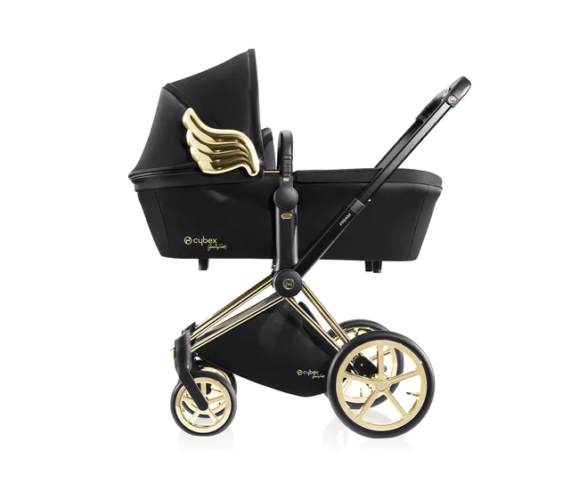 Black Cybex pram with gold accents and wing design, showcasing luxury style.