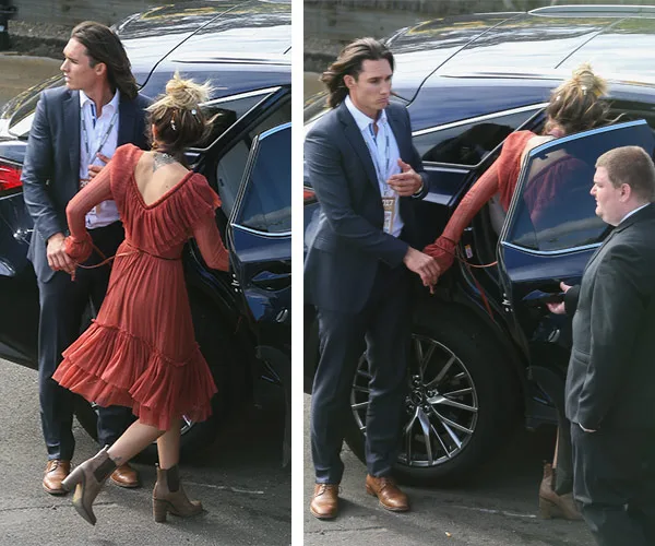 Celebrities arriving at Melbourne Cup; woman in red dress gets into car as a man in a suit assists; another man stands by.
