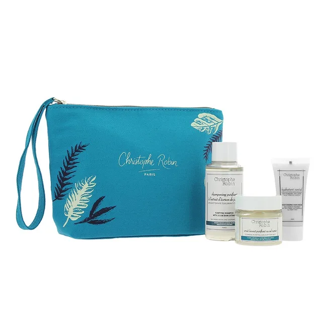 Turquoise Christophe Robin bag with three hair care products, including shampoo and conditioner.