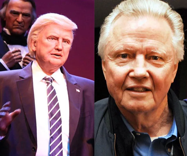 A wax figure of a man in a suit next to an older man with light hair.