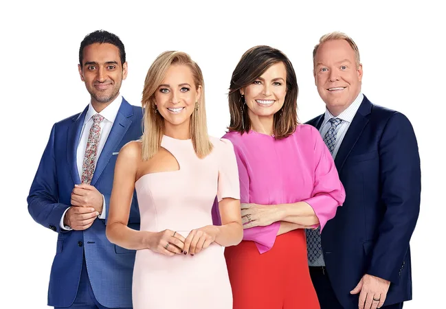 Four people standing in formal attire, smiling against a white background.