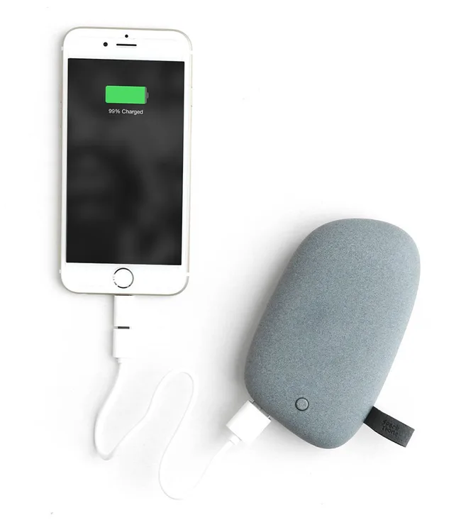 Mobile phone almost fully charged, connected to a gray pebble-shaped power bank via a white charging cable.