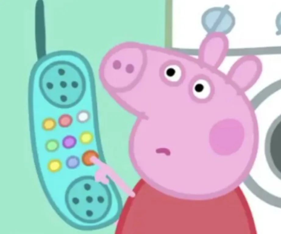Peppa Pig pressing a button on a colorful toy phone, looking curious.