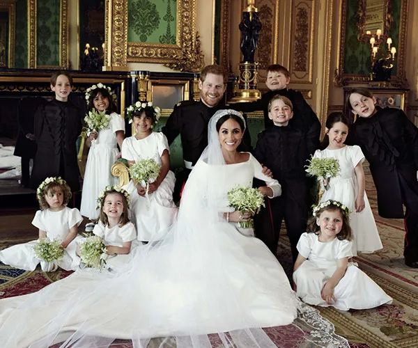 Prince Harry and Meghan Markle pose with bridesmaids and page boys in a royal wedding portrait at Windsor Castle.