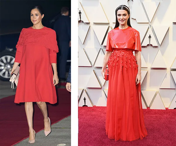 Two women in elegant red dresses on a red carpet event.