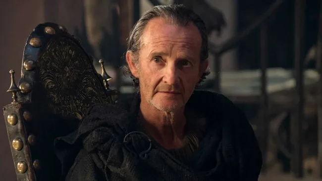A character from a medieval fantasy setting sits on a throne, wearing dark robes, with a serious expression.
