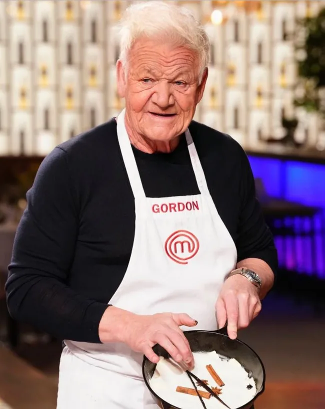 Chef in white apron with "Gordon" name tag, holding a pan with cinnamon sticks and star anise.