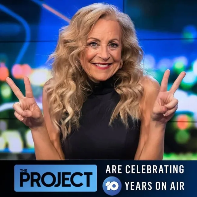 A woman with long wavy hair smiles and holds up peace signs. "The Project" celebrates 10 years on air.