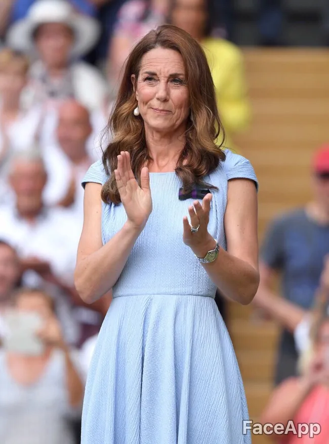 A woman in a blue dress claps at an outdoor event.