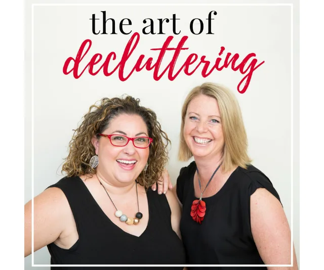 Two women smiling in front of text that reads 'The Art of Decluttering.' One wears glasses, both in black tops.