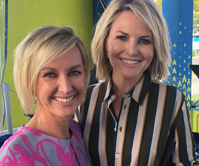 Two women smiling, standing close together, with colorful background elements.