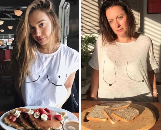 Two women wearing shirts with line drawings of breasts, standing with plates of food in front.