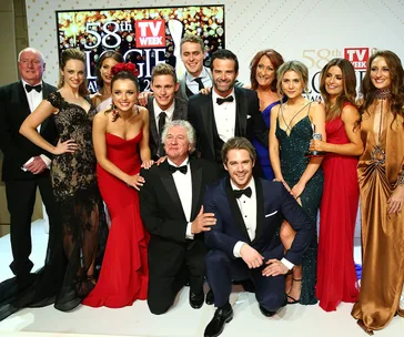 Group of well-dressed individuals at the 58th TV Week Logie Awards event, posing with a trophy.