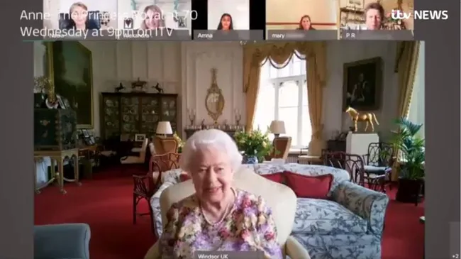 Chat with elderly woman in a floral dress on a video call in a lavish room with a gold horse statue.