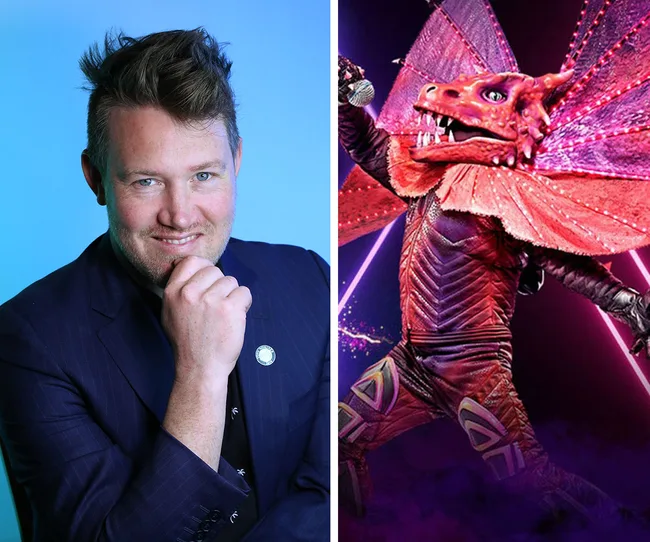 "Man smiling in a suit beside a performer in a vibrant dragon costume on The Masked Singer Australia 2020."