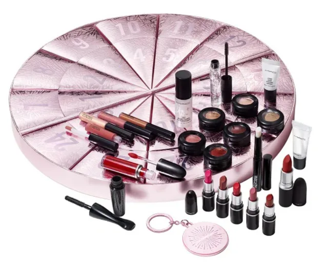 A round makeup set with various lipsticks, eyeshadows, and beauty products displayed on a pink sectioned base.