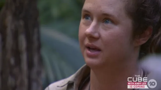 A person with short hair looking up in a forest setting, with a logo for "The Cube with Andy Lee" in the corner.