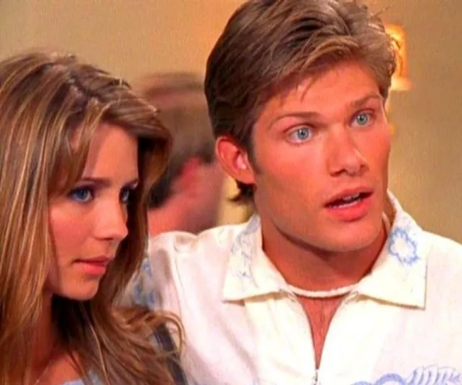 A young man and woman look surprised. The man has short brown hair; the woman has long blonde hair.