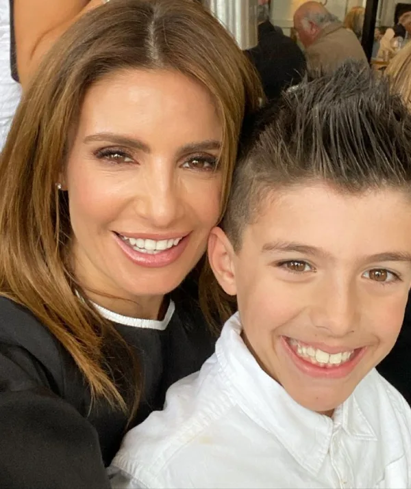 A woman and a young boy smiling in a close-up selfie.
