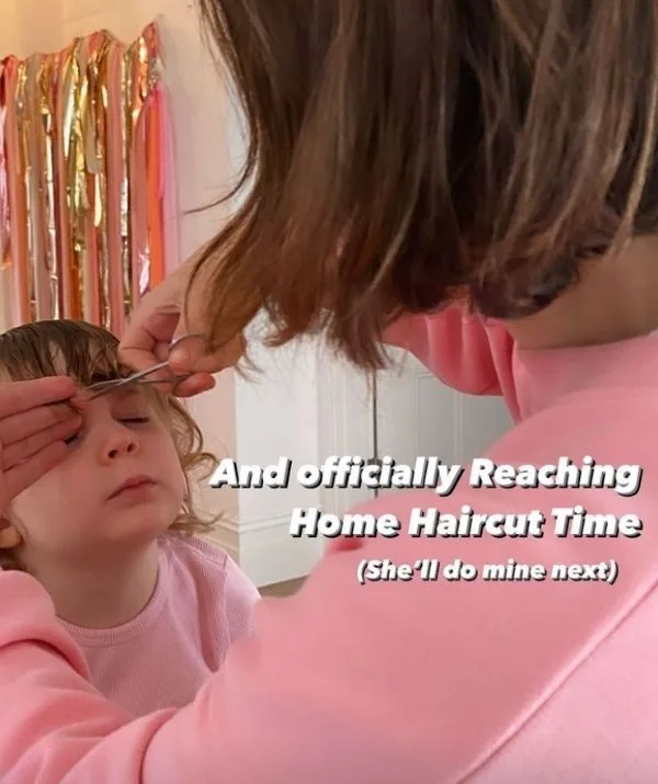 A child getting a haircut at home by a woman in pink, text reads "And officially Reaching Home Haircut Time."